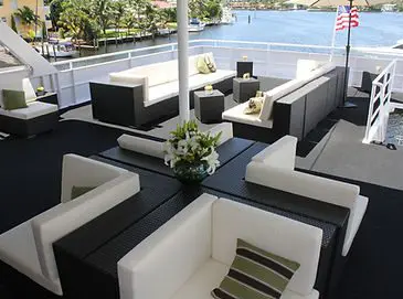 A room with many couches and tables on the deck