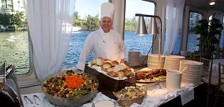 A chef standing in front of a buffet table.